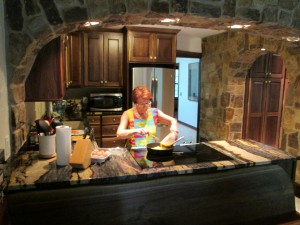 Abuelita in New Kitchen Remodel. Lots of stonework, wavy edge walnut cabinets & eating nook benches